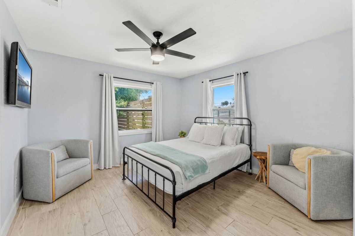 Second bedroom with queen bed and armchairs