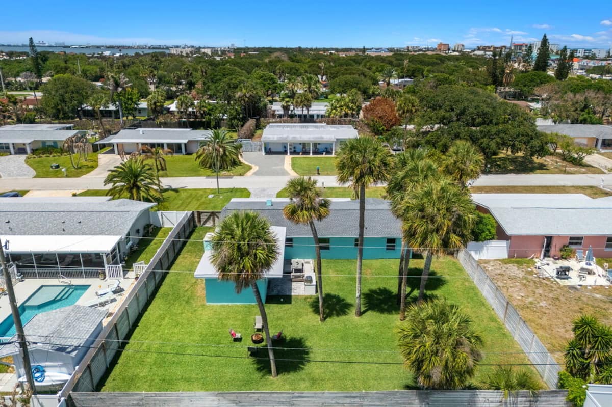 Aerial view of the beach house and fenced yard near the ocean
