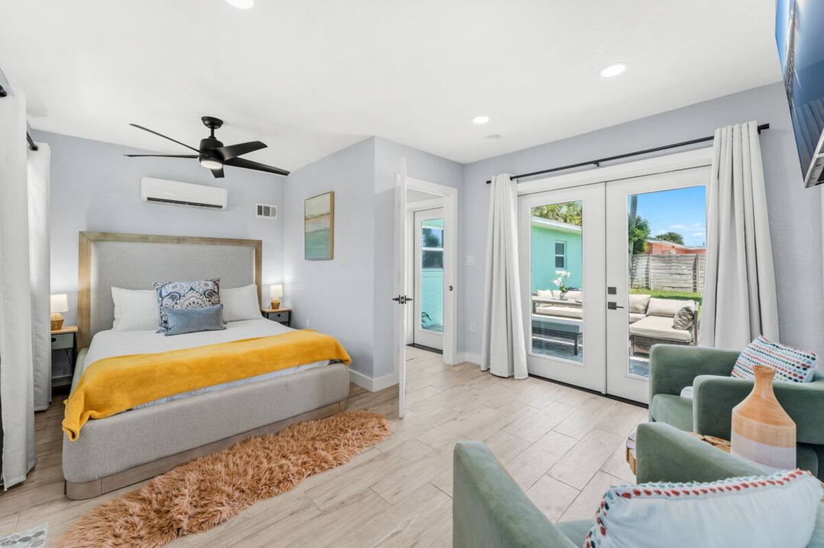 Primary bedroom with queen bed and private backyard access