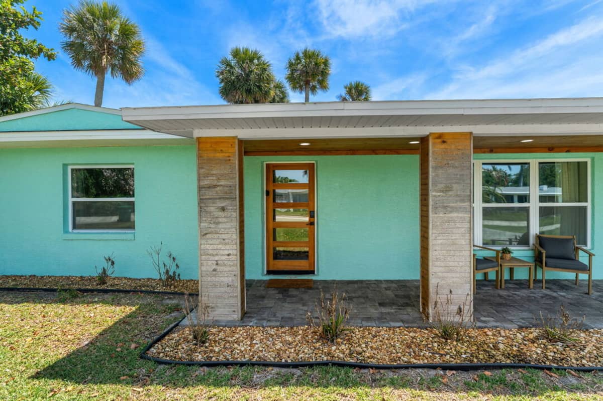 Covered front entry with wood accents and seating