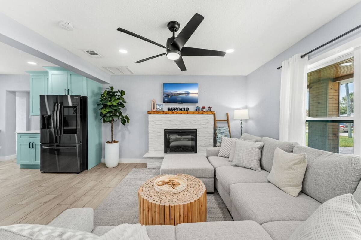 Living area with fireplace, smart TV and coastal decor