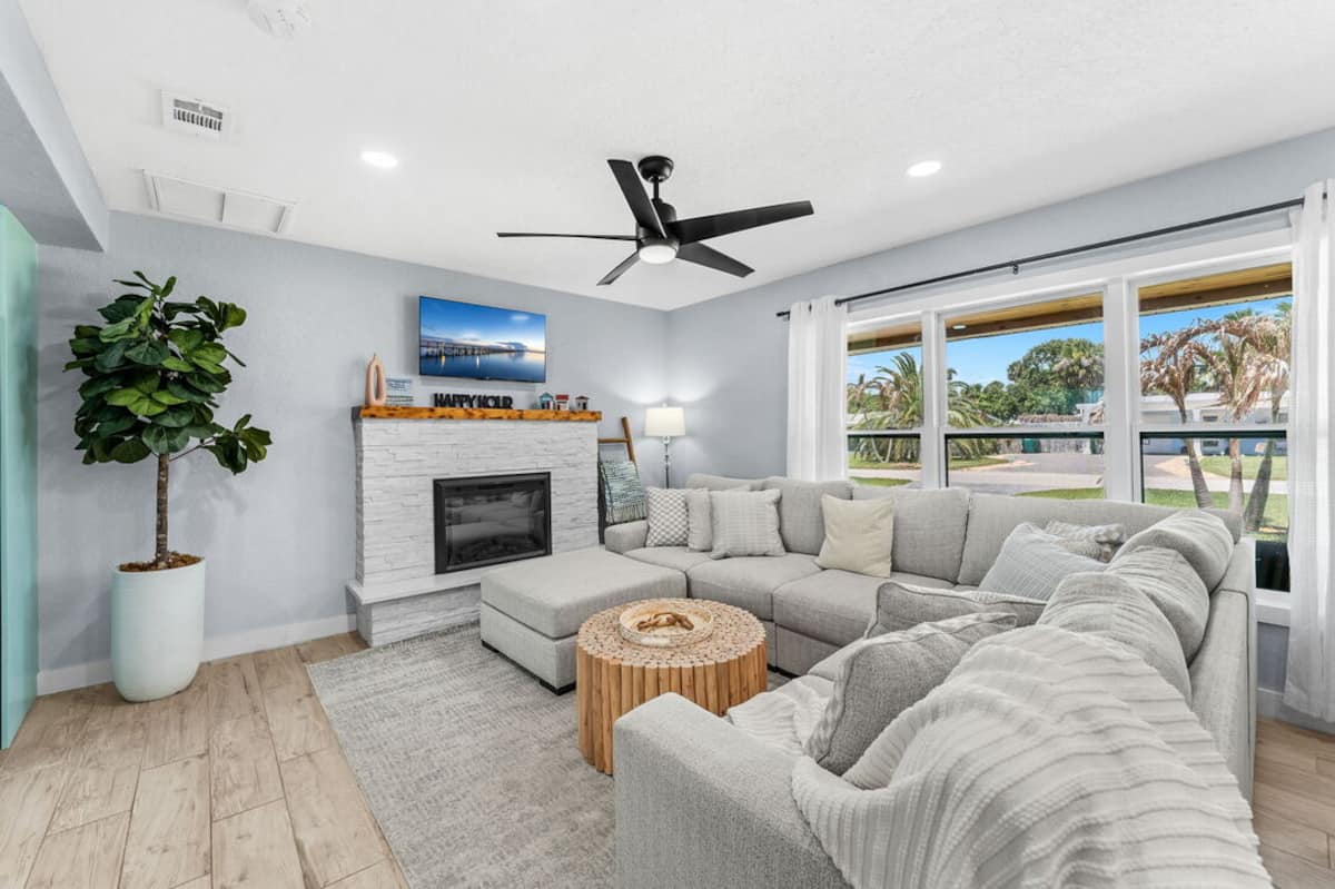 Bright living room with vaulted ceiling and large windows